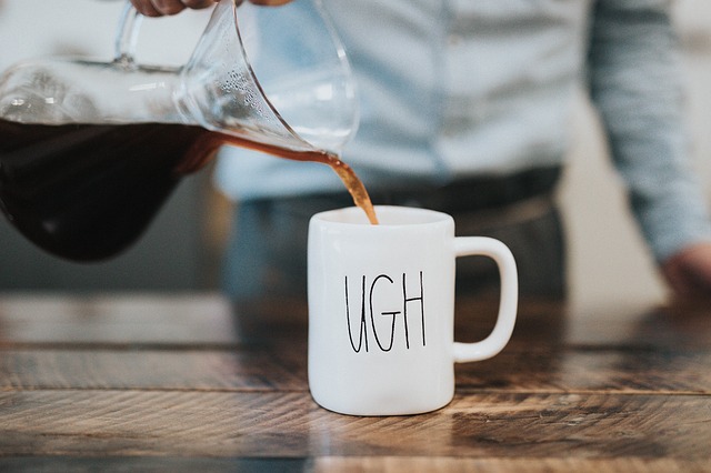 Mug of coffee with "UGH" written on it.